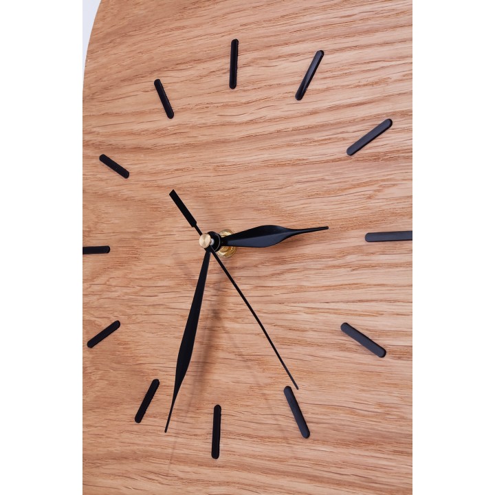 Oval clock made of oak plywood